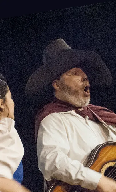 Omar y Sandra San Lucas, durante una interpretación de canción con guitarra en la obra teatral infantil Copérnico, el gato con botas, por La Carpa de la Luna, en Guayaquil, Ecuador